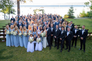 Wedding couples friends and family posing for a photo overlooking lake tahoe