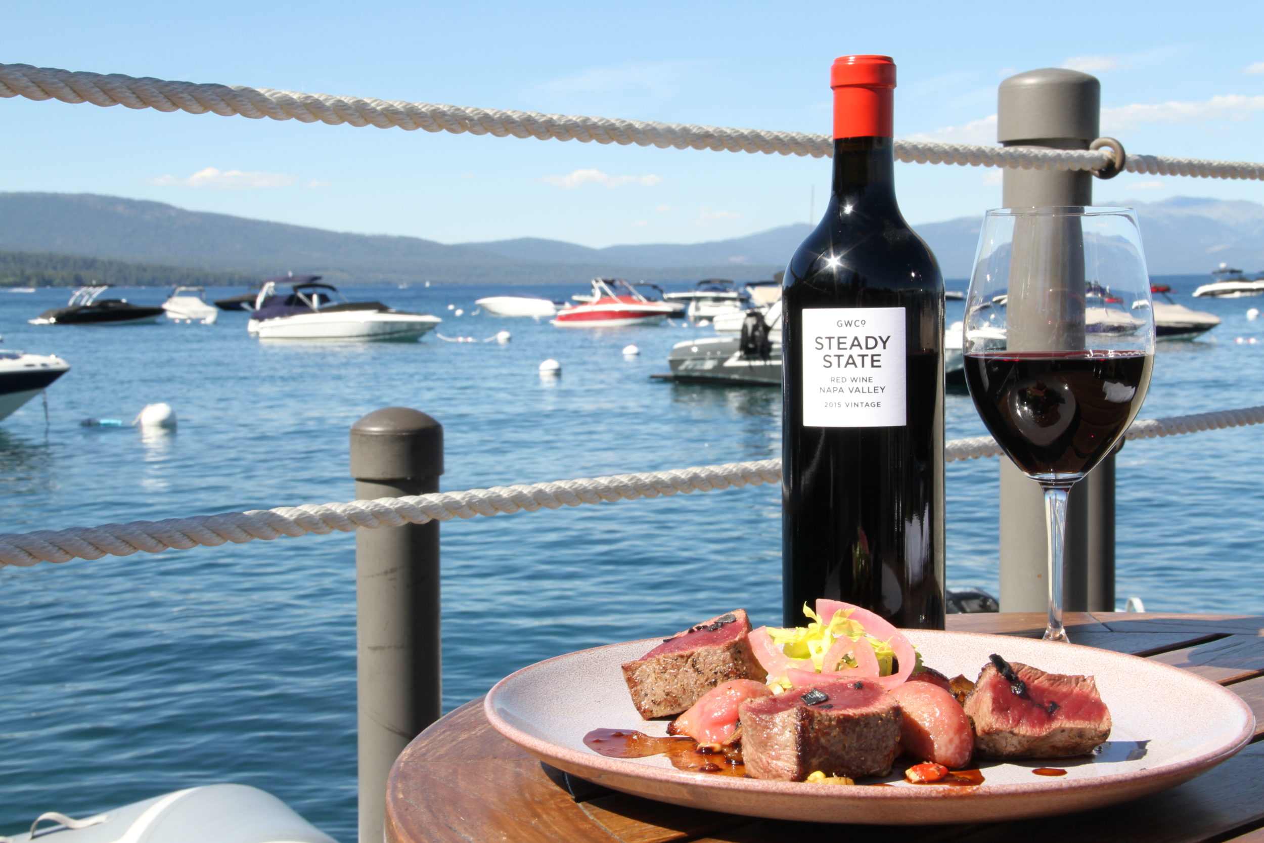 West Shore Cafe Dinner Special. Elk Tenderloin and Stead State Red Wine from Napa Valley. Lake Tahoe in the background.