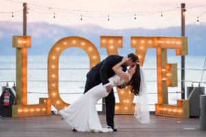 Couple kissing on West Shore Cafe pier