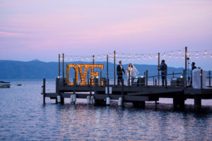 Pier with lit up sign that says love on west shore cafe pier
