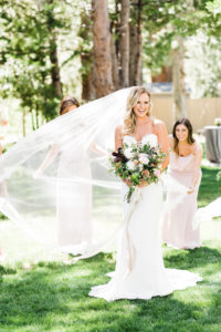 bridesmaids helping bride with dress