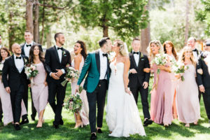 Bride and Groom kissing with wedding party