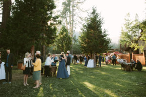 People enjoy a wedding reception on the West Shore Cafe lawn.