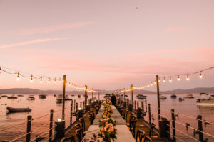 West Shore Cafe Pier set for dinner. A sunset overlooking Lake Tahoe in the background.