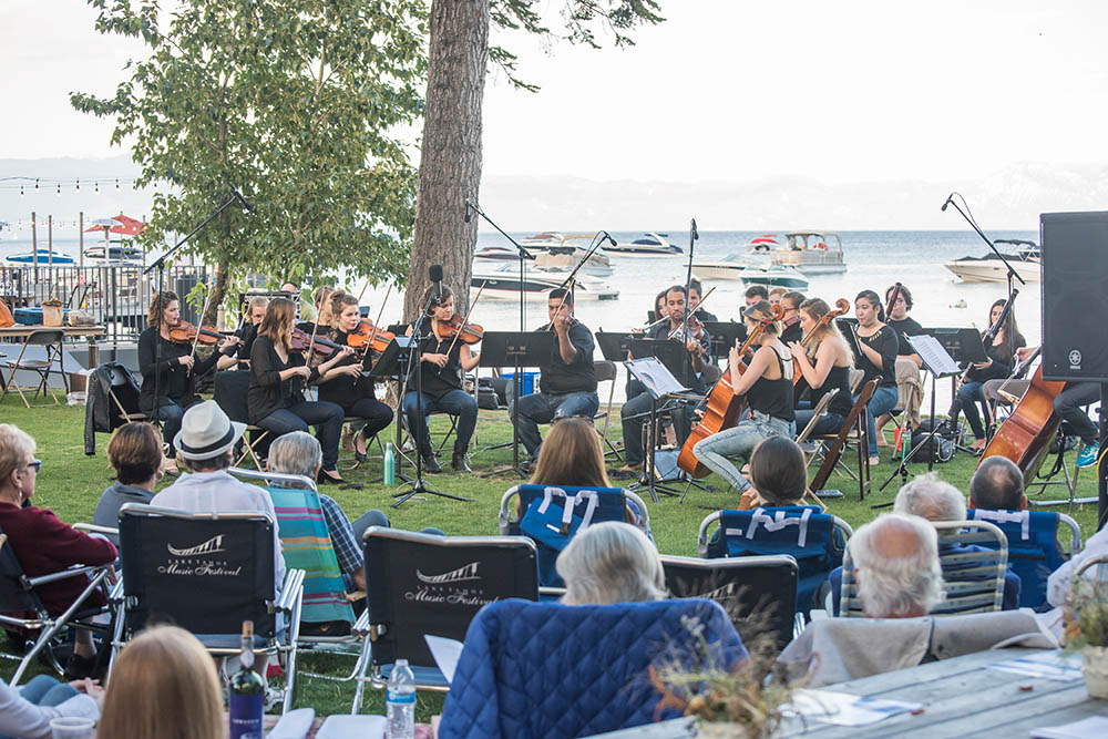 Lake Tahoe Music Festival plays on the West Shore Cafe Lawn with Lake Tahoe in the background.